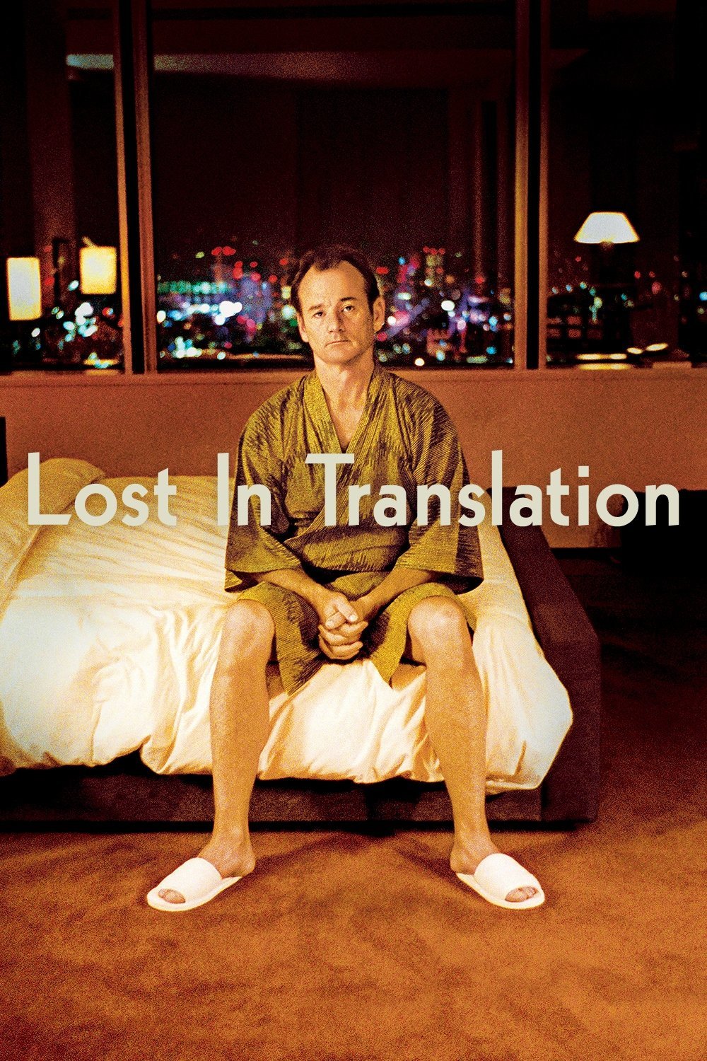 A man sitting on a bed in a hotel room at night, wearing a kimono and slippers, with a cityscape visible through the window in the background. Overlaid text reads 'Lost In Translation'.