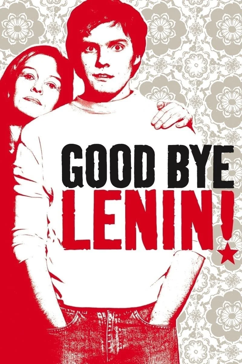 A poster with a young man holding a sign that reads 'Good Bye Lenin!' in bold black and red letters. A woman is partially visible behind him. The background features a decorative floral pattern in gray and white.