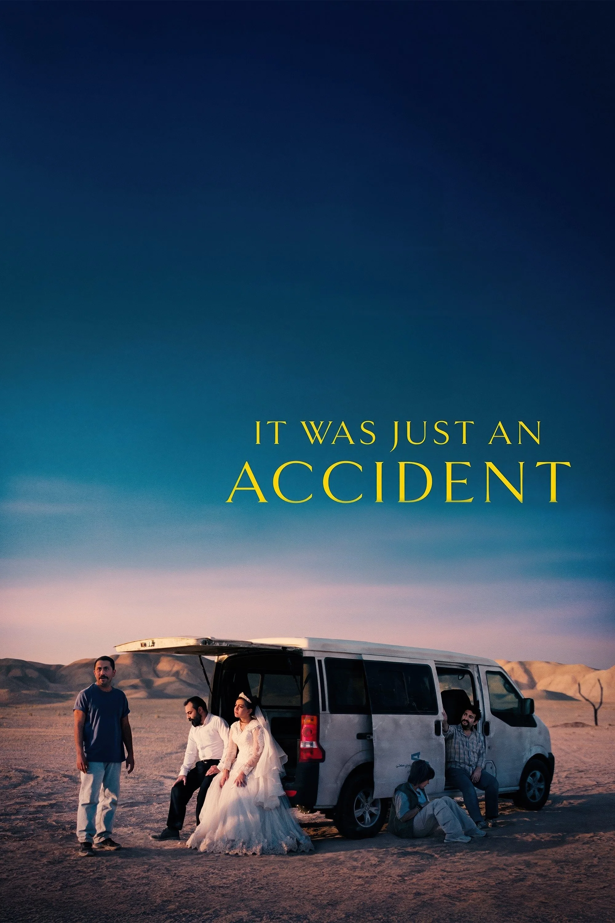 A group of people standing and sitting near a van in a desert landscape at sunset, with mountains in the background, and the text 'It was just an accident' overlaid on the sky.