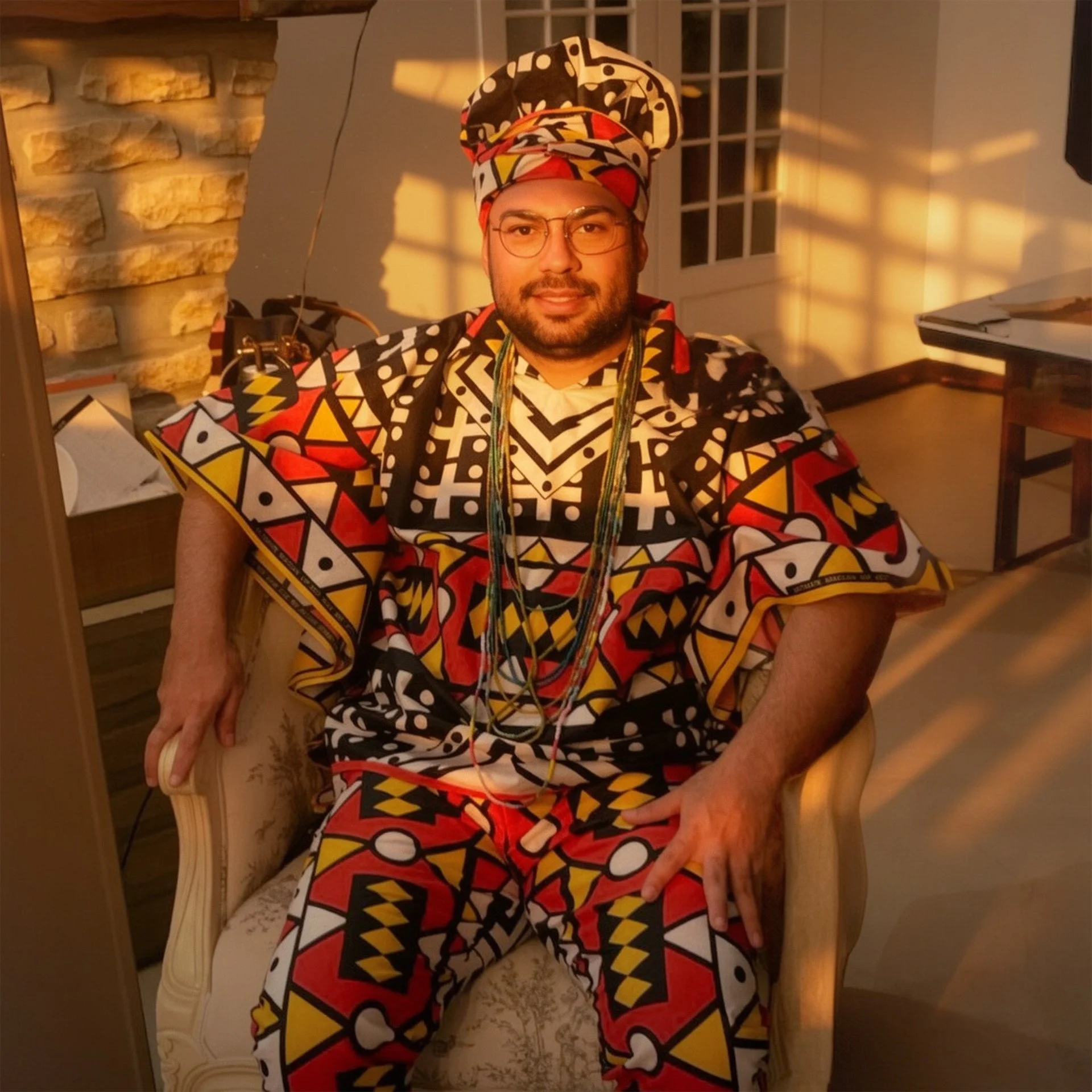 Trion, ancestral ritual facilitator at KAIRÉ in traditional patterned indigenous attire