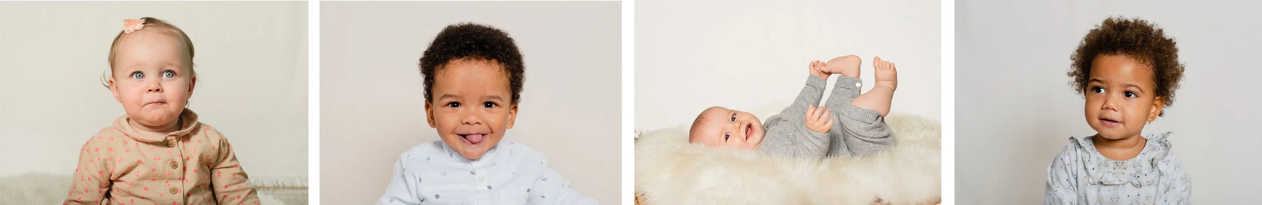Four babies sitting or lying on a soft surface, with neutral background, wearing different outfits.