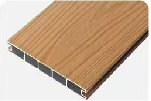 Close-up of a wooden textured vinyl siding panel with a black core and white trim edge.