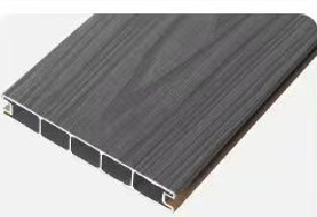 Close-up of a gray composite decking board showing its textured surface and hollow underside.