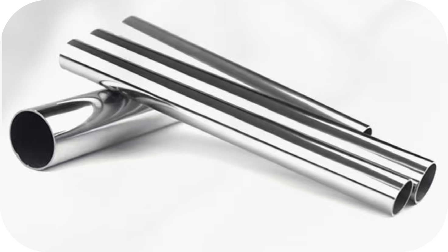 Three chrome exhaust pipes, two straight and one curved, arranged on a white surface.