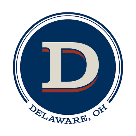 Logo featuring a large letter 'D' in white with red accents inside a dark blue circle, with the words 'DELAWARE, OH' at the bottom of the circle.