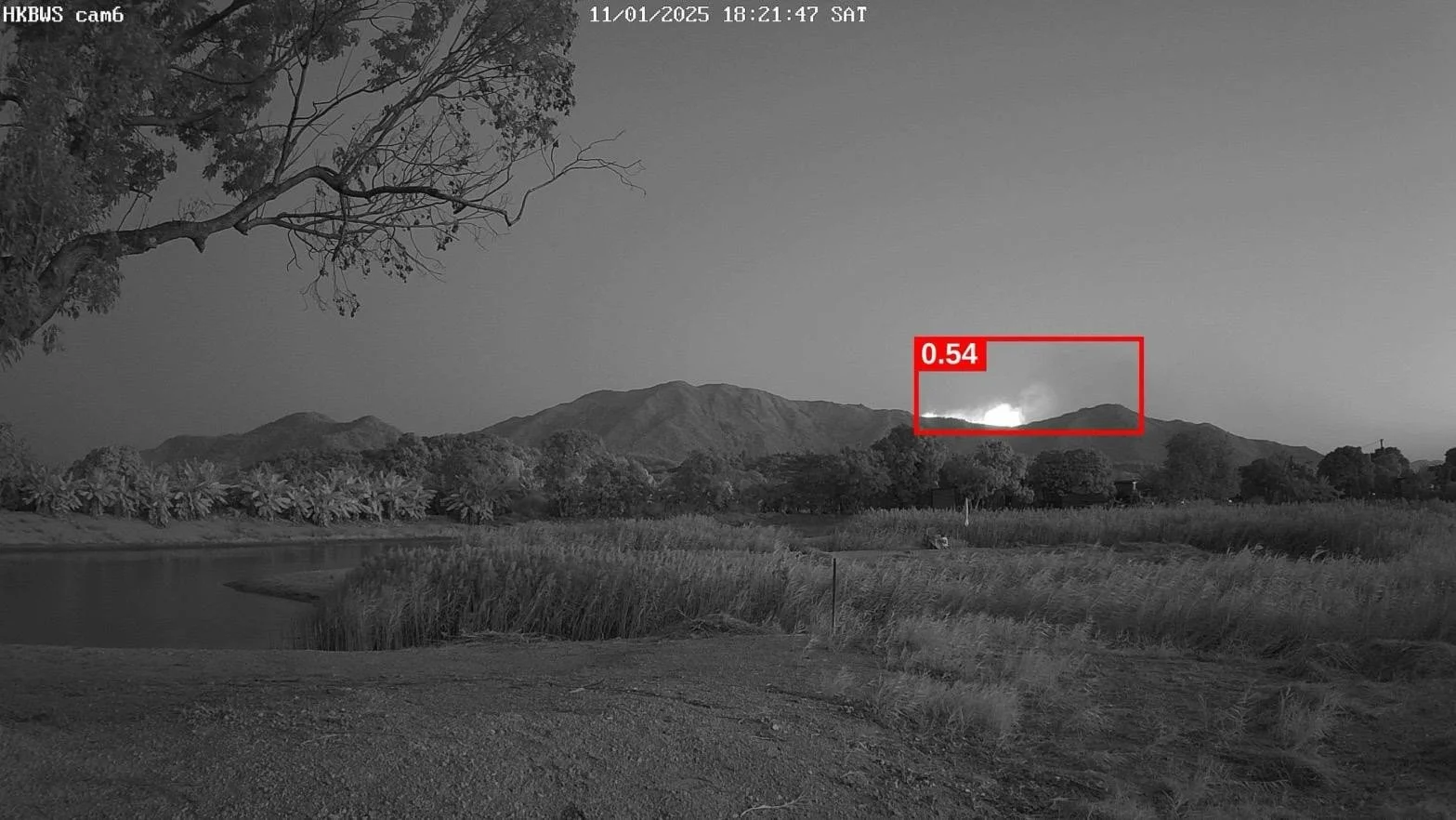 Robotics Cats LookOut camera image with an early smoke plume marked by a red detection bounding box and confidence score