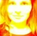 Blurry, colorful portrait of a woman with long hair, smiling, in a close-up shot.