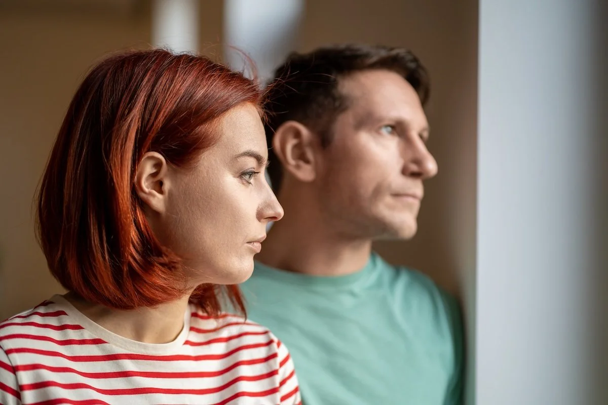 woman and man looking out of a window