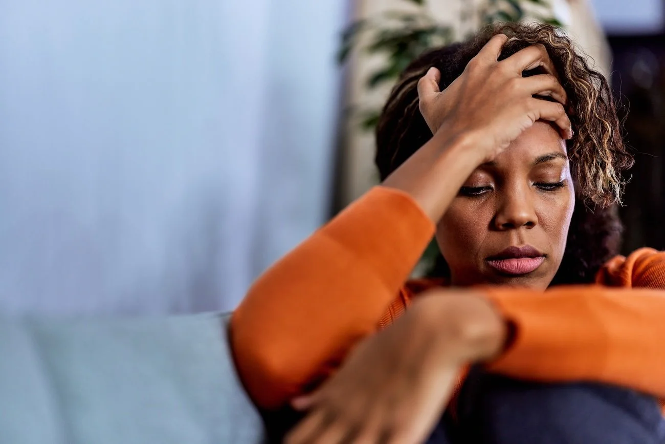 unhappy lady with hand on her head