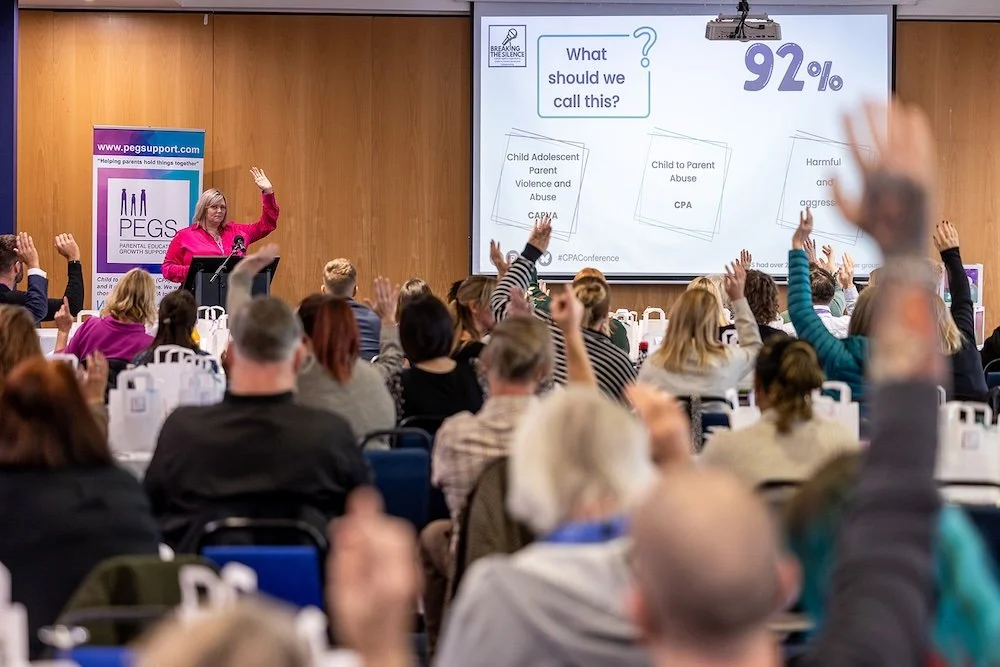 people raising hands at the PEGS conference