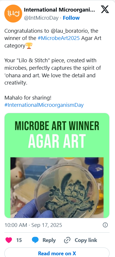Screenshot of a social media post celebrating a microbiology art contest winner. The post includes a green label with bold black and white text reading 'Microbe Art Winner Agar Art' and a photo of a petri dish with blue and white microbial art. The post congratulates the winner for creating microbial art that captures the spirit of 'ohana and art.