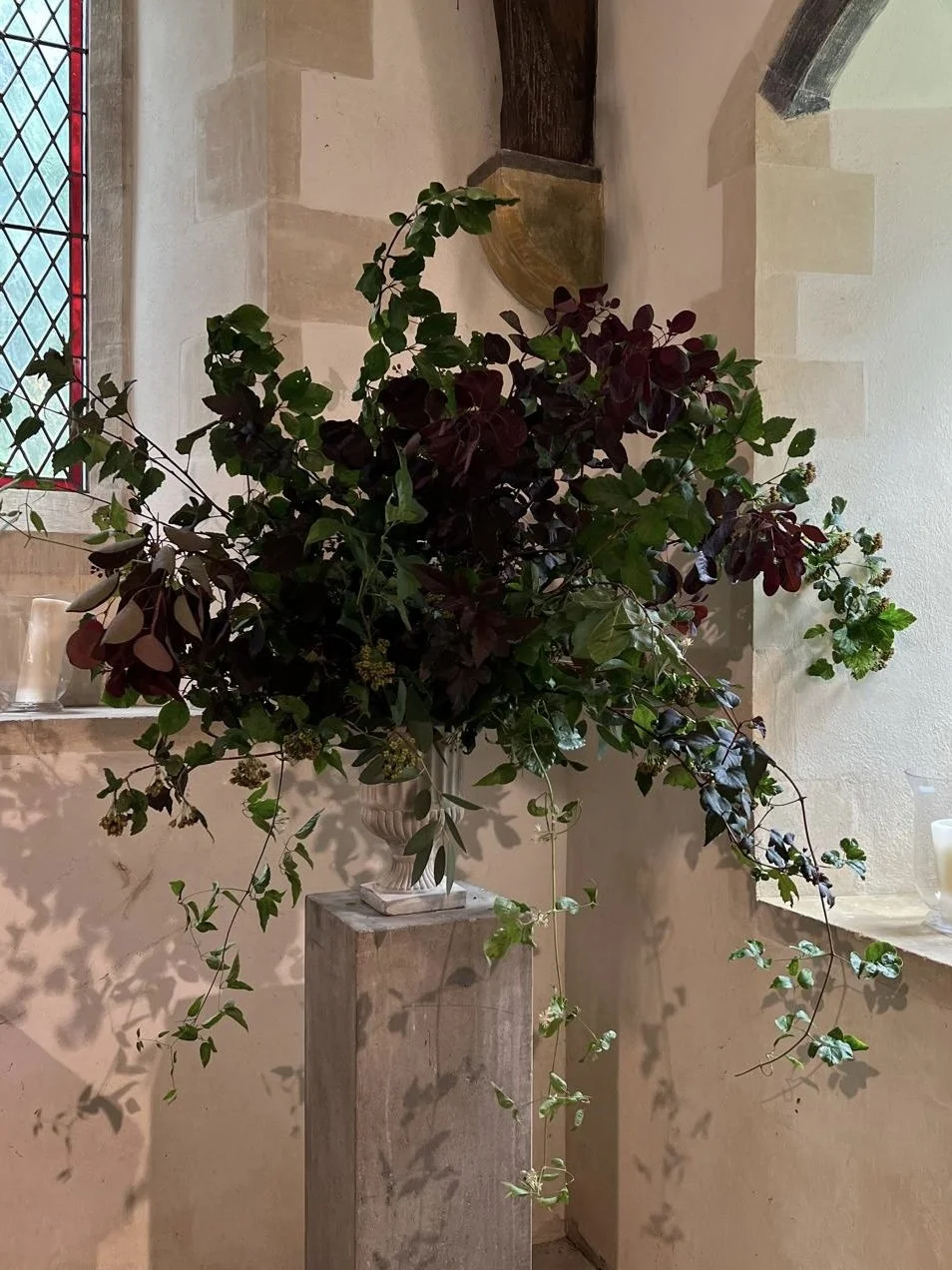 Beautiful foliage urn, Beach, Cotinus and old mans beard.  August wedding in Dorset