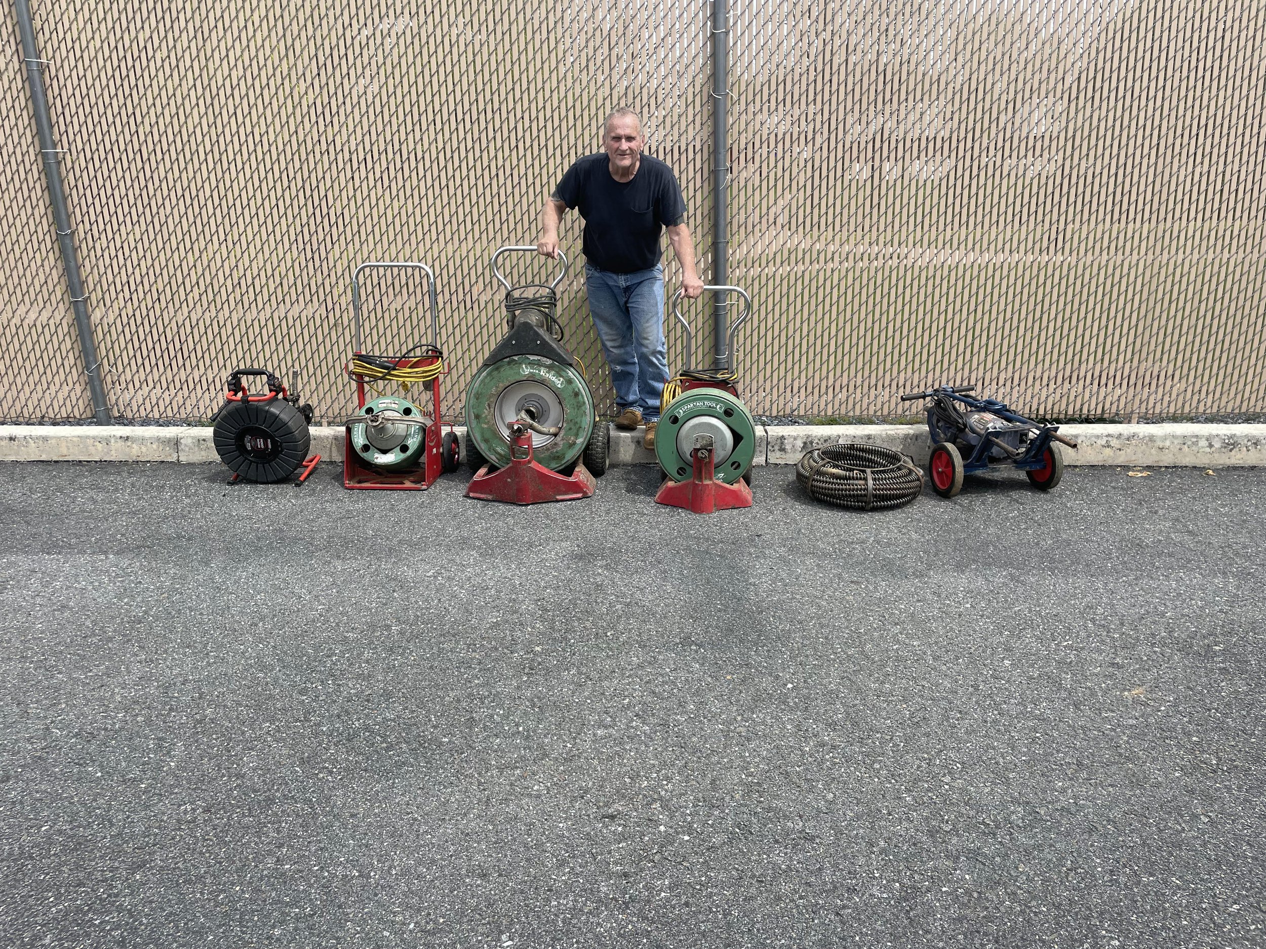 Man in front of drain cleaning equipment.