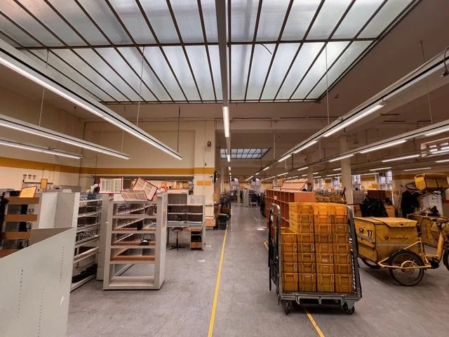 Empty store aisle with empty shelves and carts, yellow delivery vehicle in the background