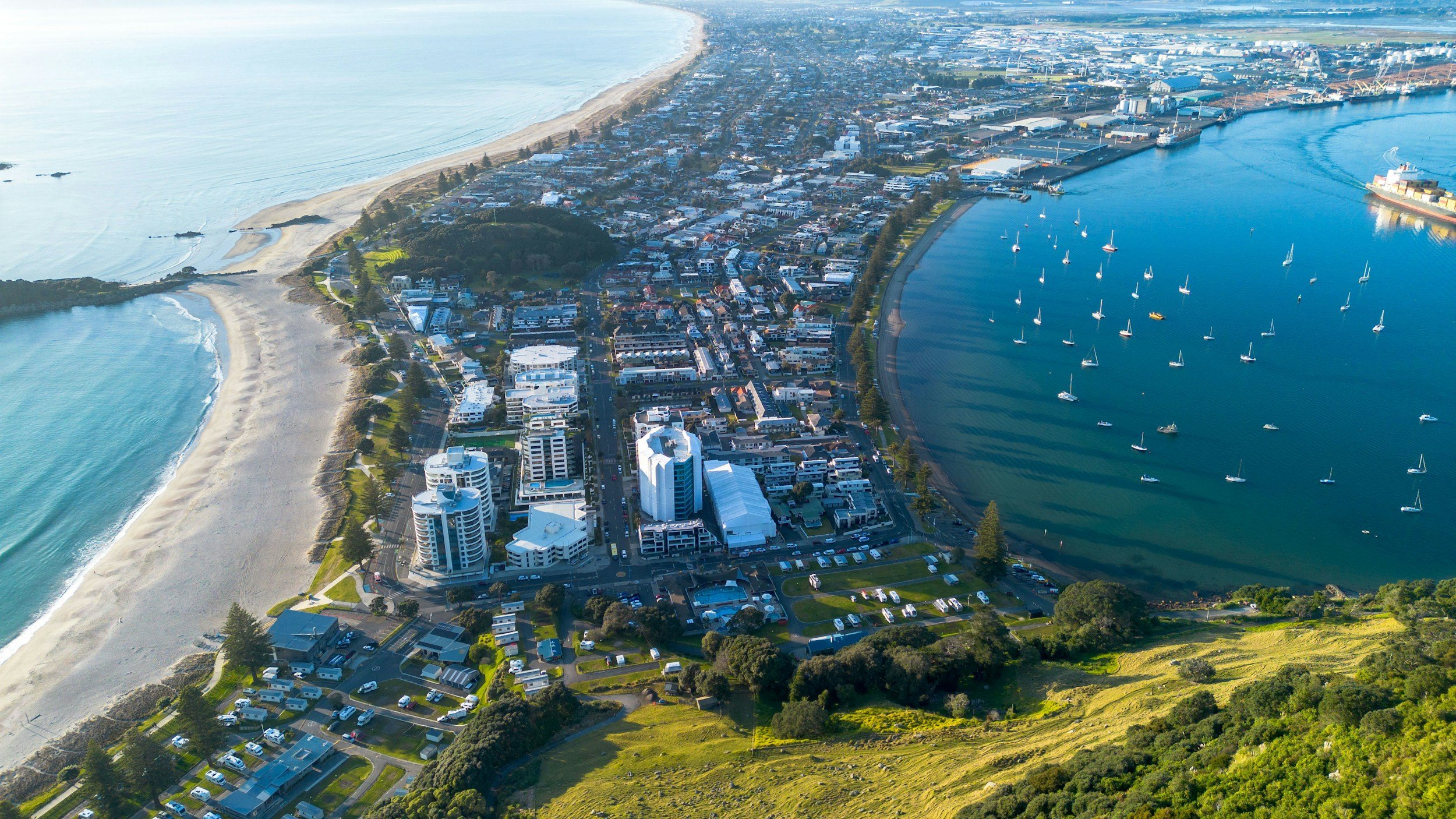 Aerial view of the Mount Maunganui coastline and beaches, highlighting the premium lifestyle available when securing an immigration NZ investment visa.