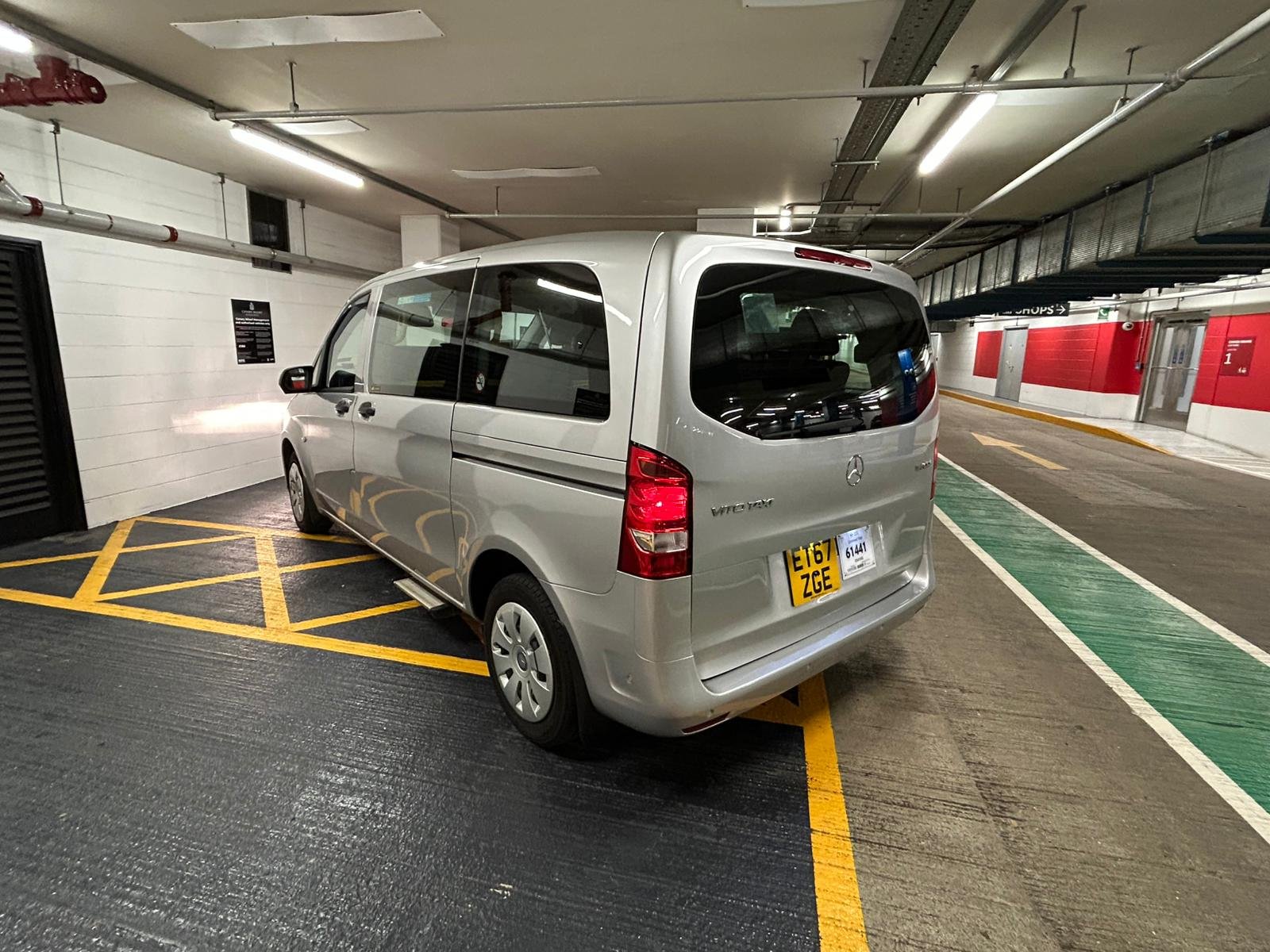 Silver Mercedes-Benz Vito van parked in a reserved parking space in an underground parking garage.