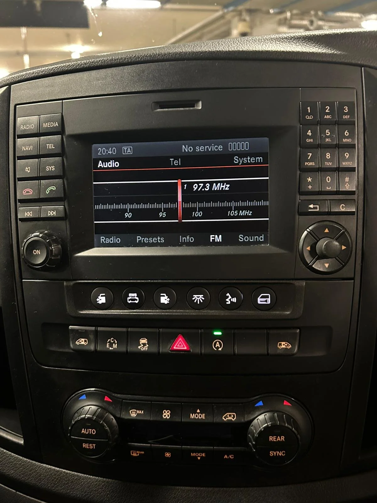 Car radio system displaying FM radio tuned to 97.3 MHz