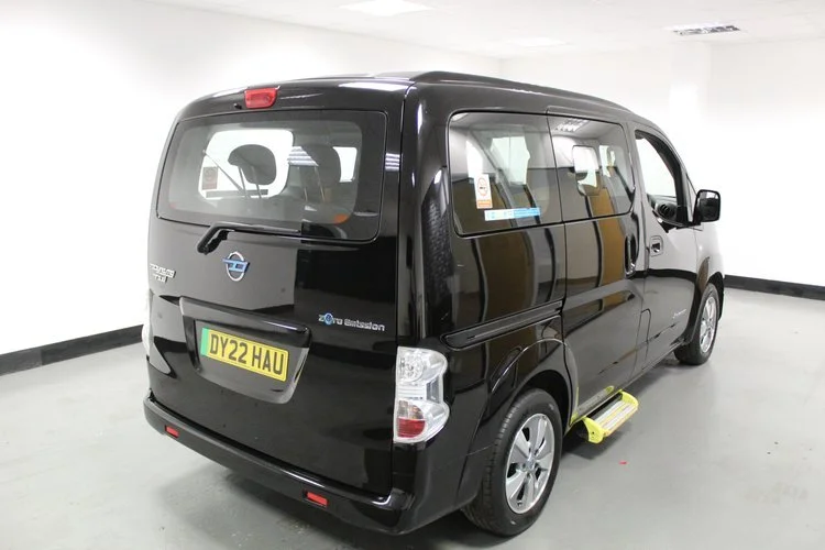 Black van with yellow license plate in an indoor parking space