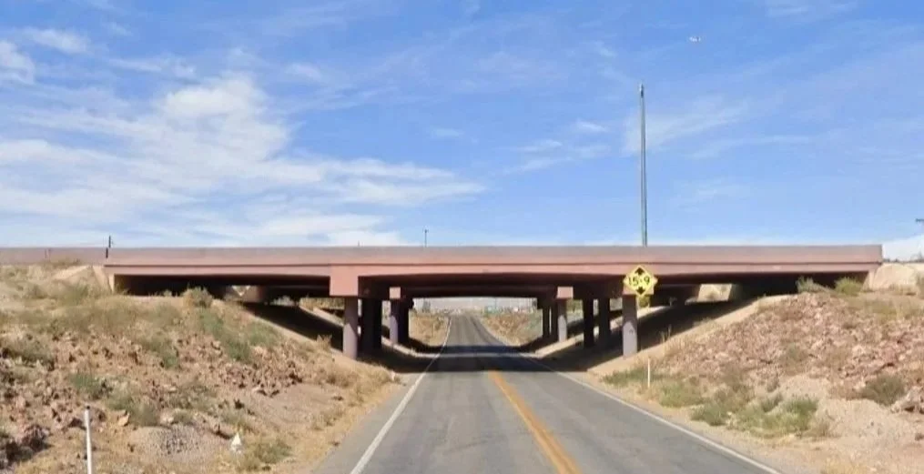 Jean interchange which provides access to Goodsprings Road (SR 161). Image is a picture of Goodsprings Road with one lane in each direction beneath I-15.