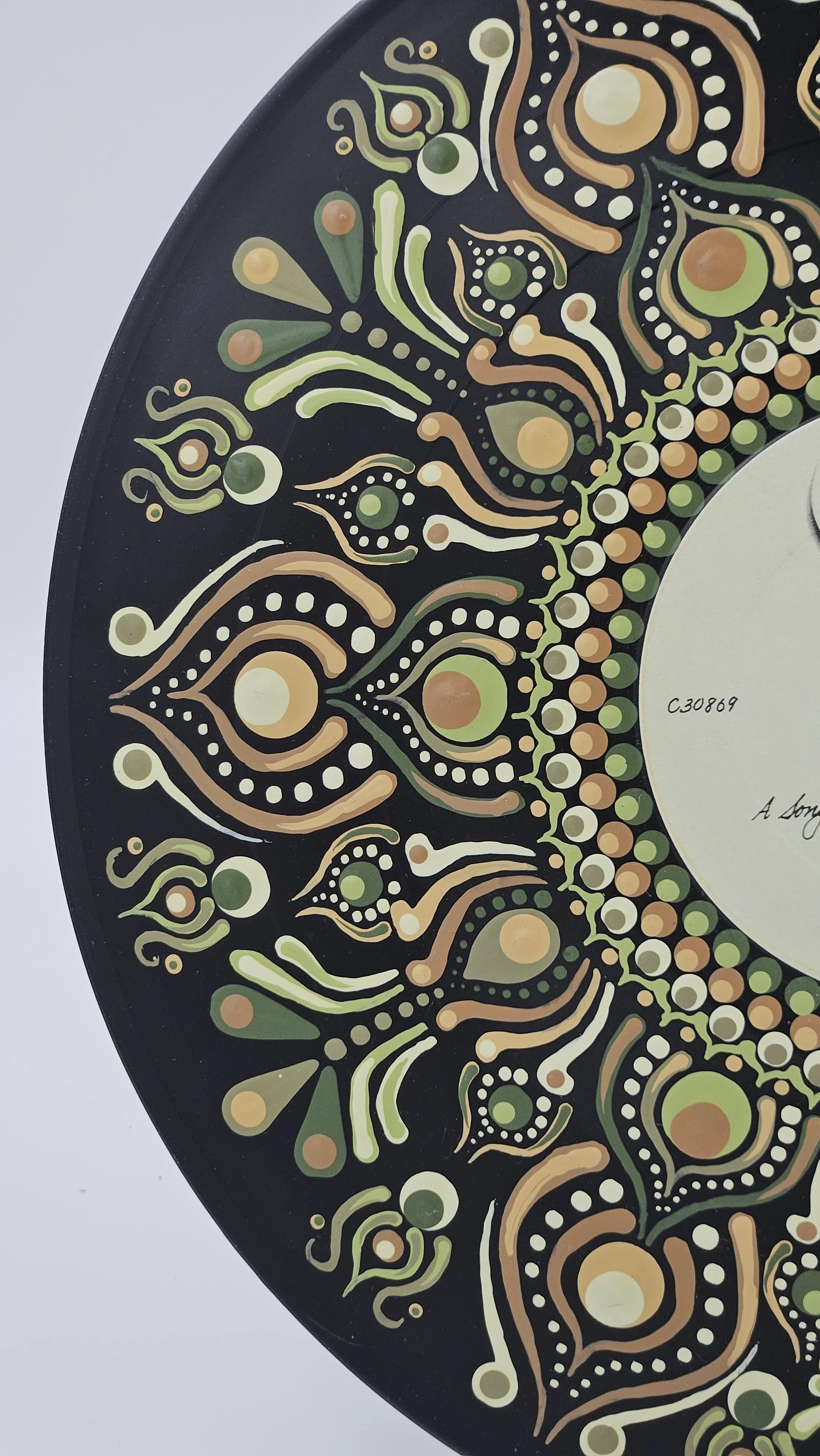 Close-up of green cream and gold hand-painted mandala detail on Chicago At Carnegie Hall vinyl record