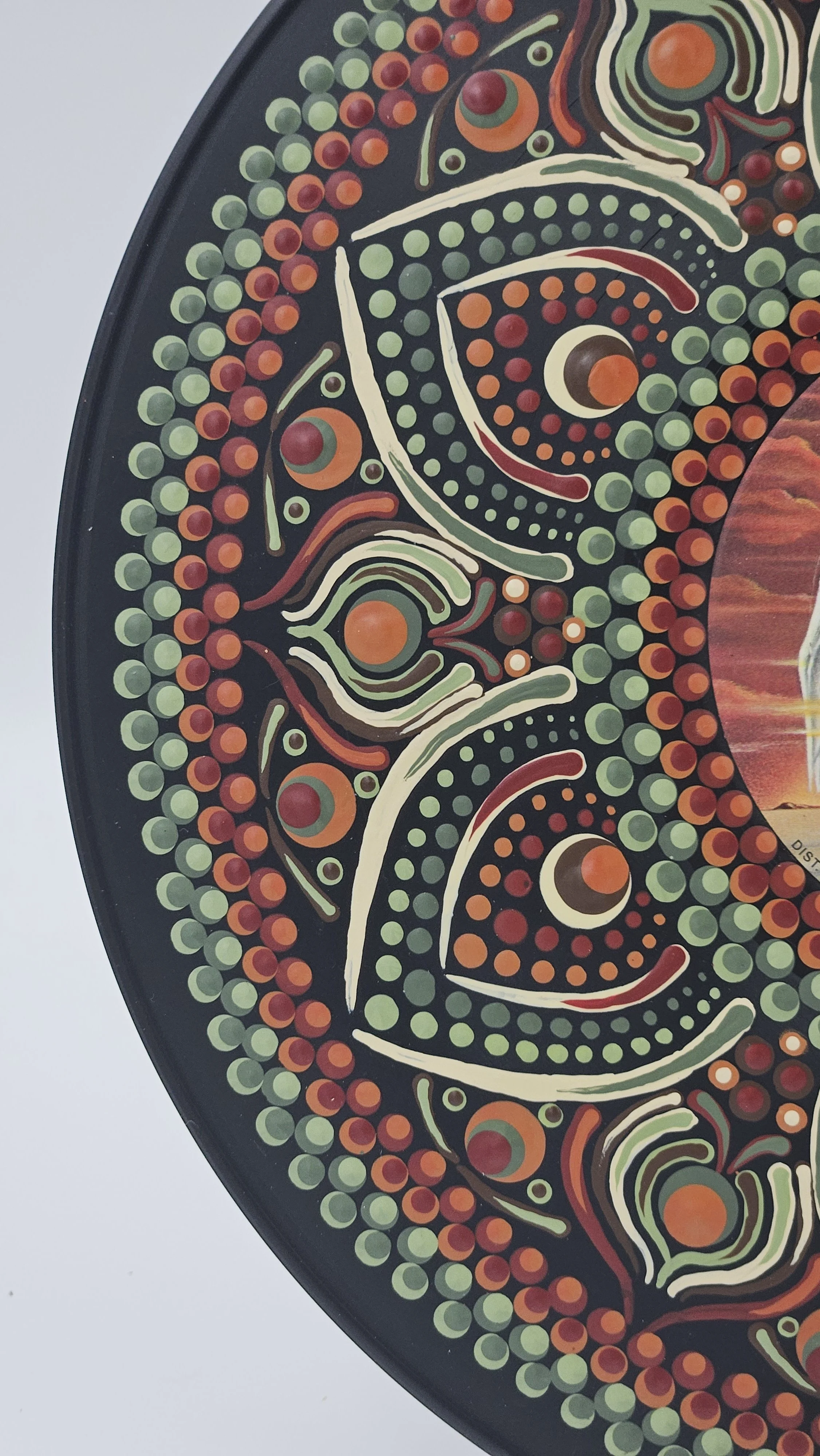 Detailed close-up of Bad Company vinyl record mandala art, showcasing individually applied drops of acrylic paint in burnt orange, deep red, sage green, and ivory, forming intricate curved patterns an