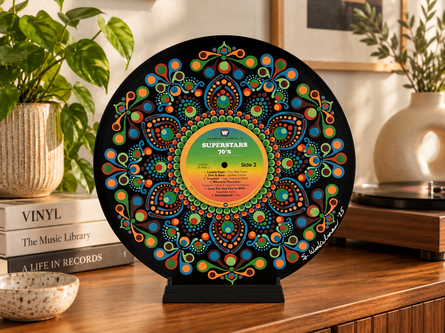 Superstars of the 70's hand-painted vinyl record art displayed on a tabletop stand in a warm retro-inspired room setting