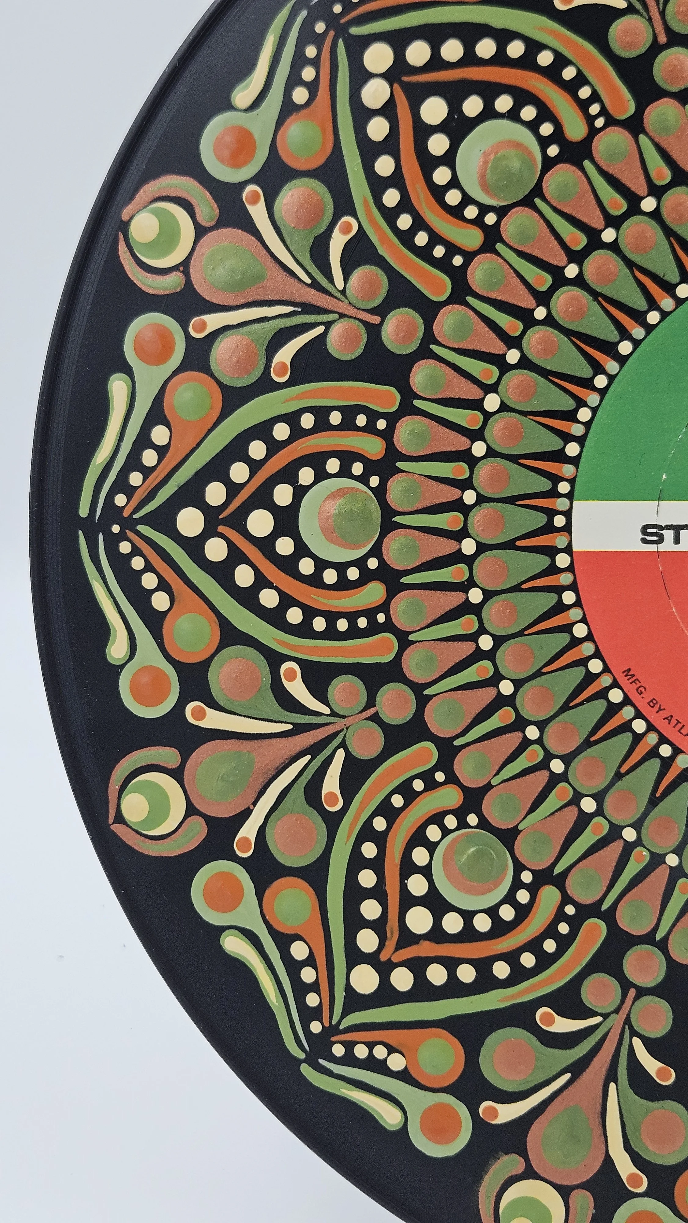 Close-up of olive green rust and cream hand-painted mandala detail on Bette Midler vinyl record art
