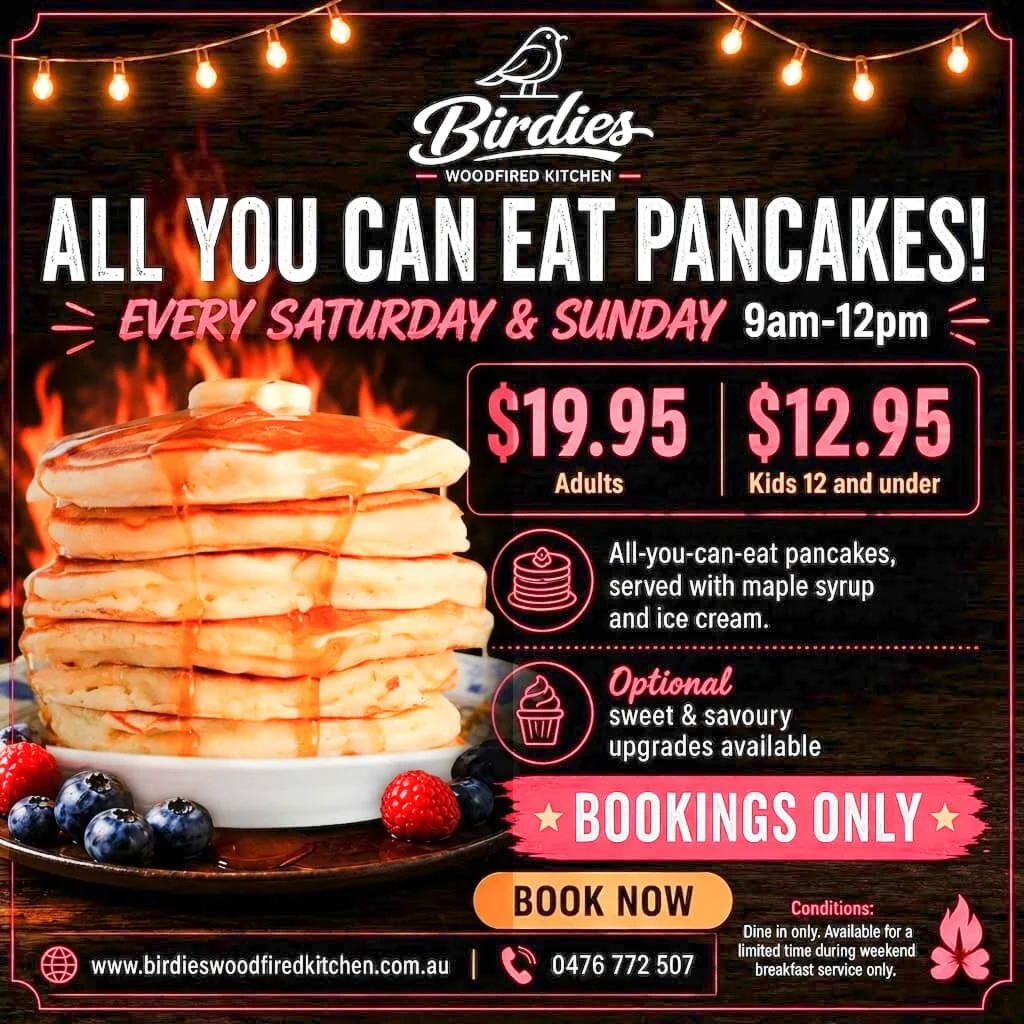 Advertisement for Birdies Woodfired Kitchen promoting all-you-can-eat pancakes every Saturday and Sunday from 9am to 12pm, priced at $19.95 for adults and $12.95 for kids 12 and under, with optional sweet and savory upgrades,  bookings only. The image features a stack of pancakes with syrup and berries, with a background of string lights and a dark wooden backdrop.