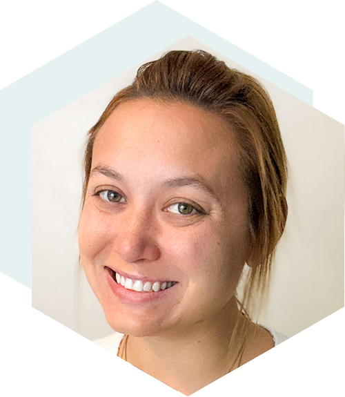 Smiling woman with light brown hair tied back, wearing a white top, set against a neutral background with a hexagonal design overlay.