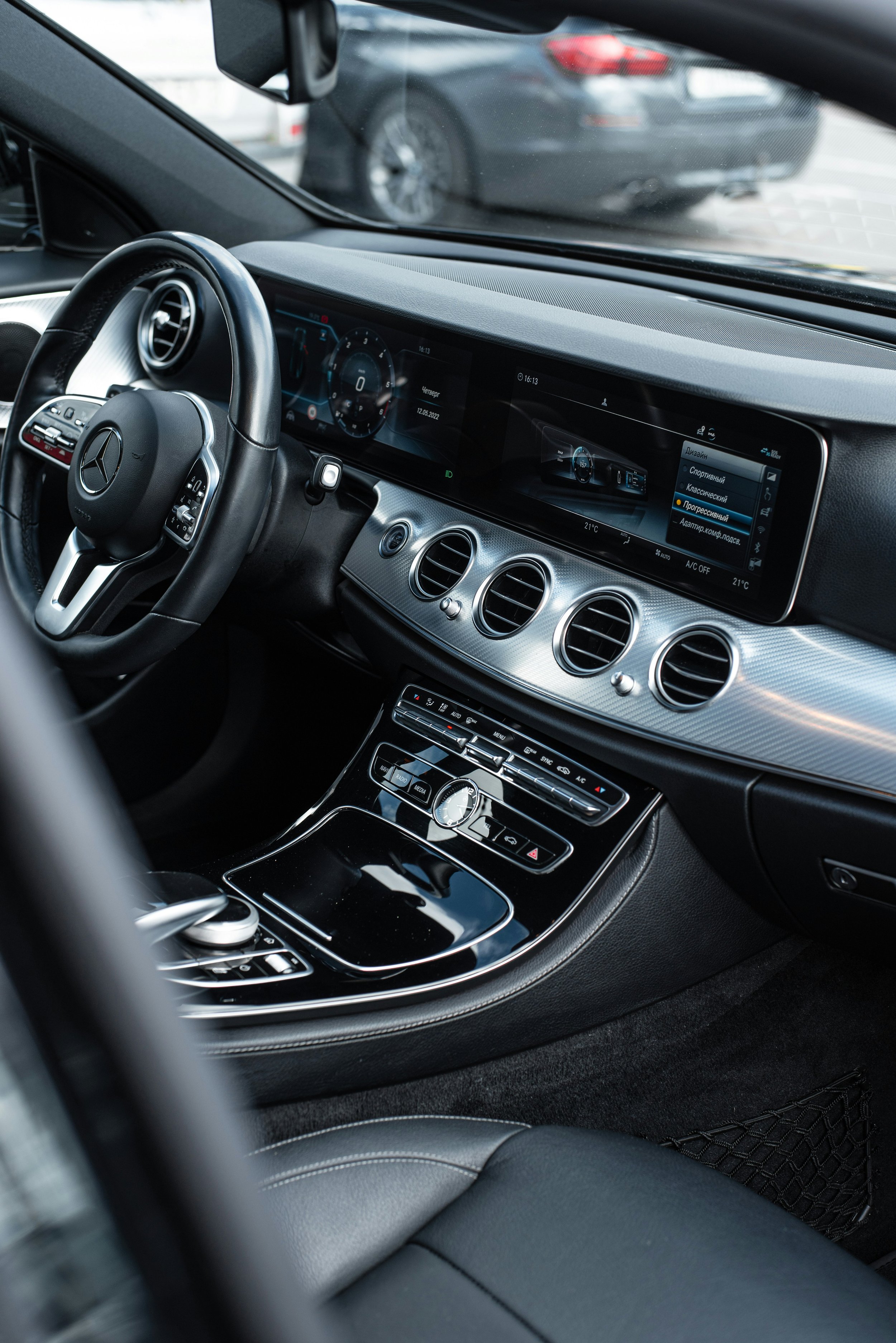 Interior of a Mercedes-Benz vehicle showing the dashboard, steering wheel, and central control panel.