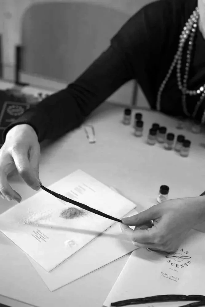 Perfumers evaluating raw vanilla ingredients for fragrance formulation.