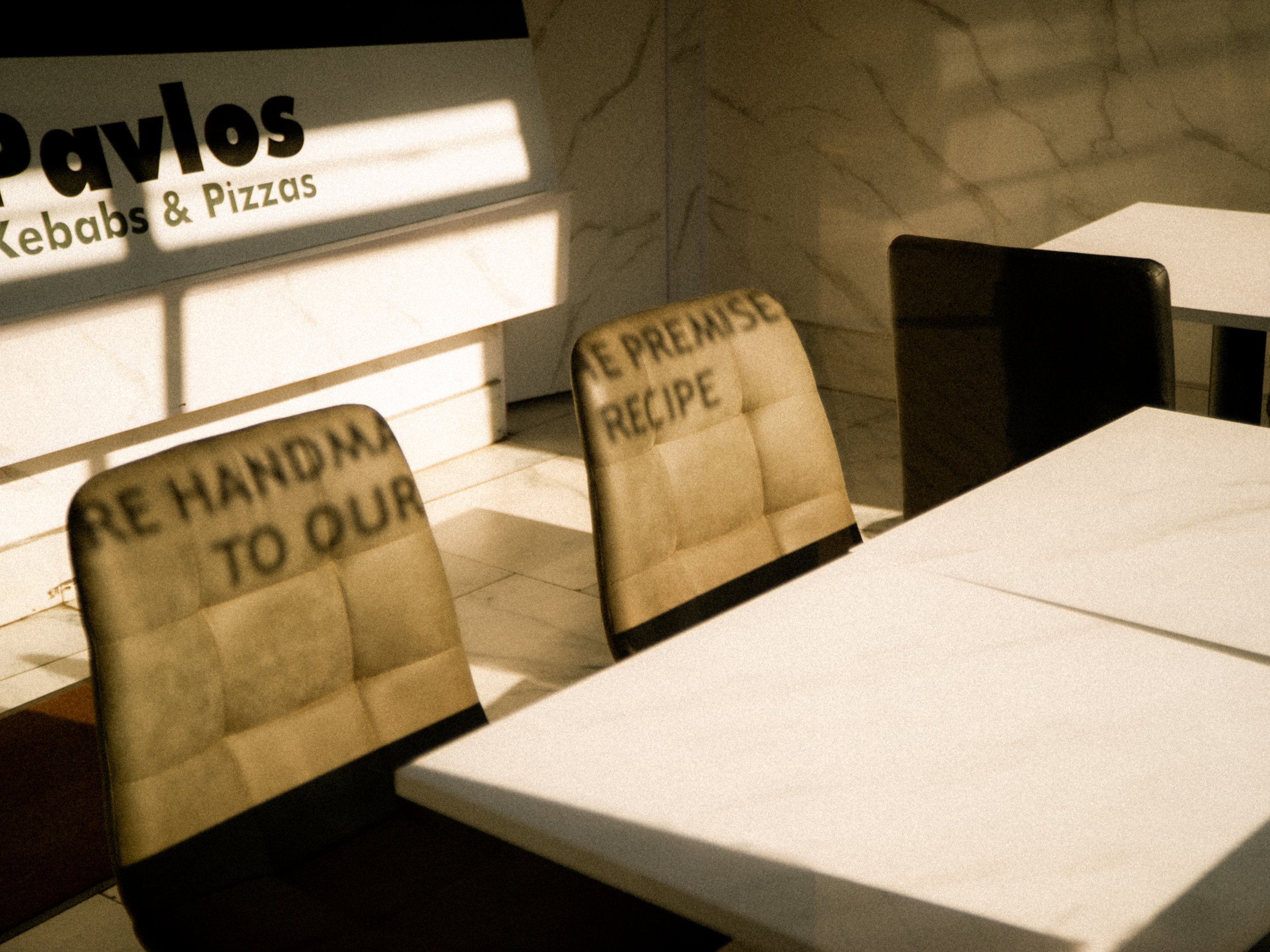 Shadows of restaurant chairs on the wall and table in a cafe or restaurant