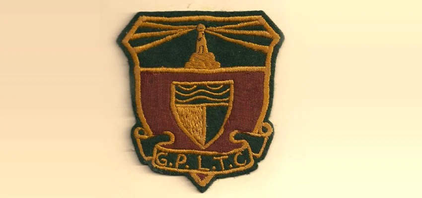 An embroidered patch with a shield shape featuring a lighthouse and a shield with waves, and the initials G.P.L.T.C.