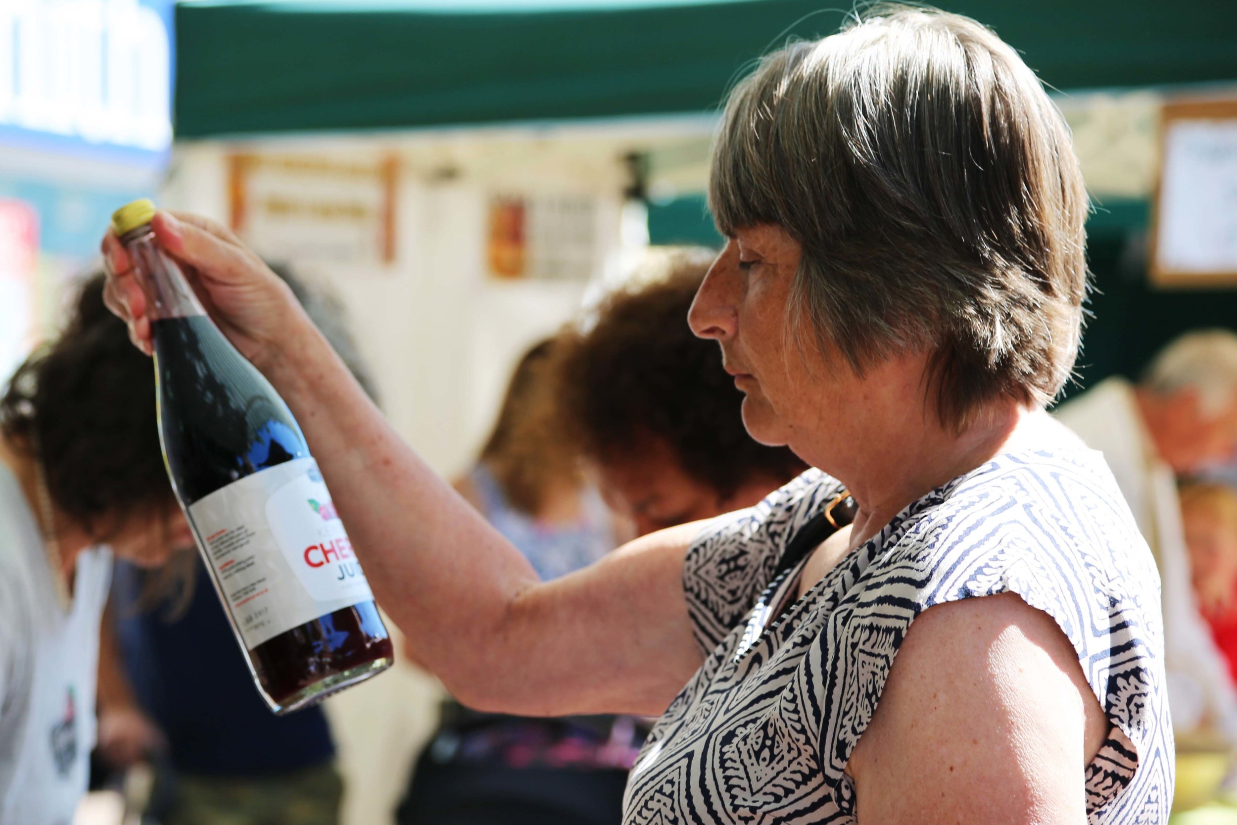 Woman looking at Dalloways cherry juice bottle