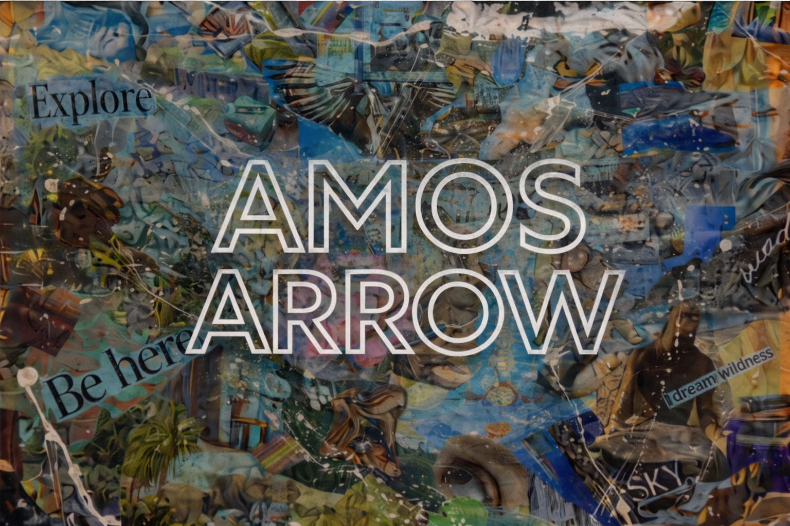 A collage background made of crumpled and layered paper with various colors and patterns, overlaid with the words 'Explore AMOS ARROW' in large white outlined letters. Additional smaller text includes 'Be here', 'dream wilderness', and other phrases.