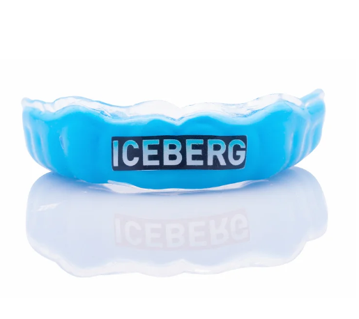 A blue dental night guard with the word 'ICEBERG' printed on it, reflected on a shiny surface.