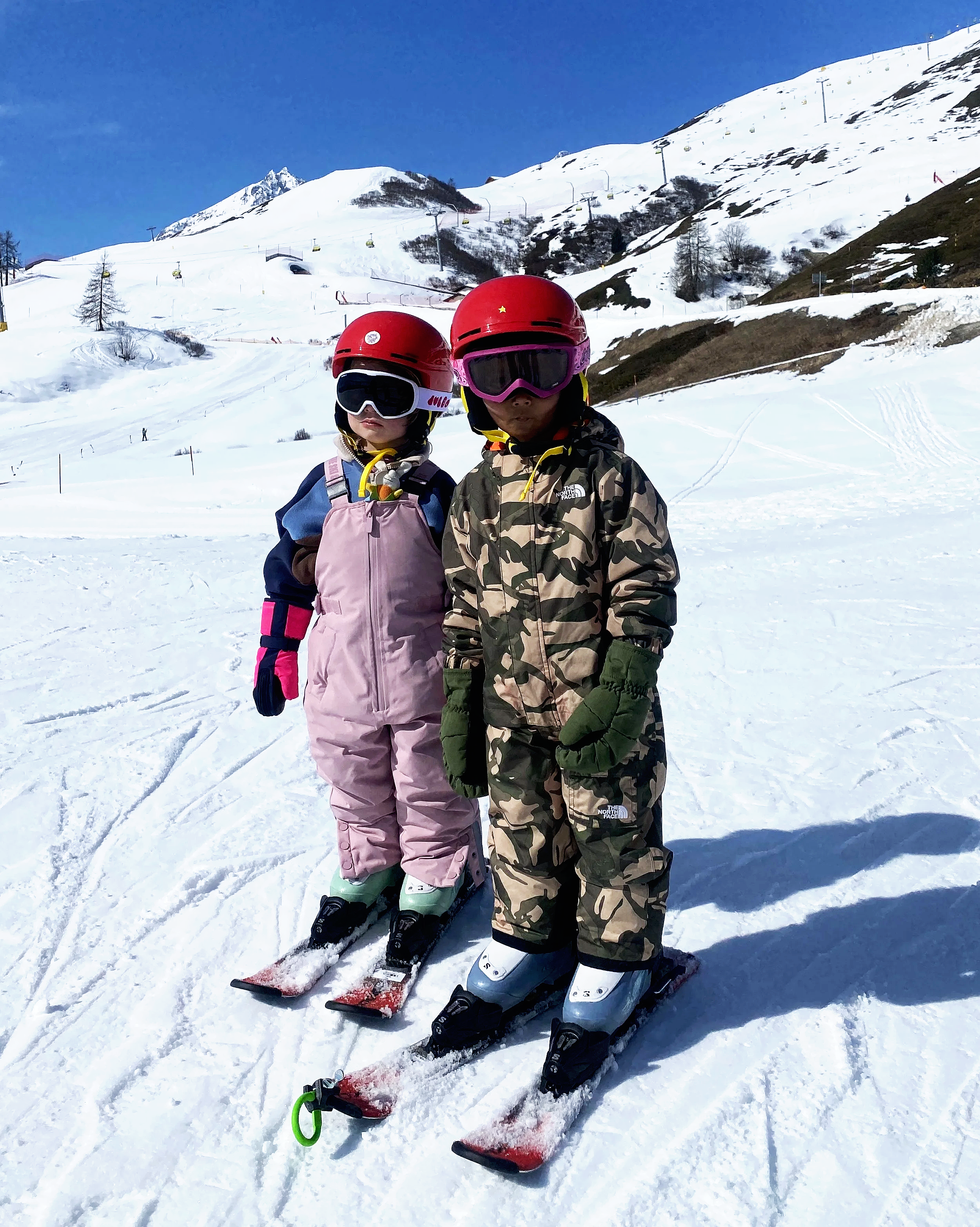 Private family ski lesson in St. Moritz with two children learning and enjoying the slopes in the Engadin.