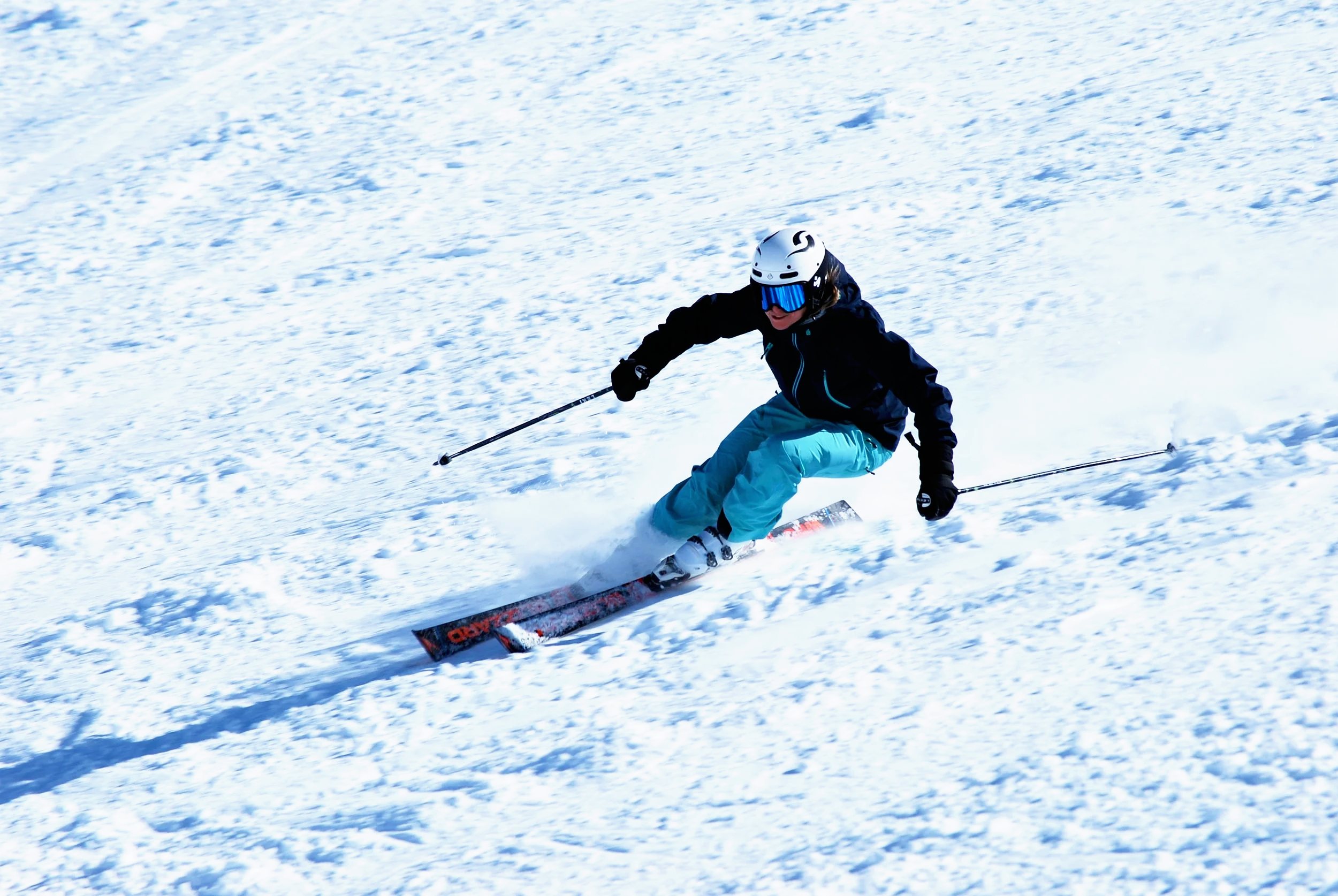 Private ski instructor carving on a groomed slope in St. Moritz during a full-day ski lesson in the Engadin, Switzerland.
