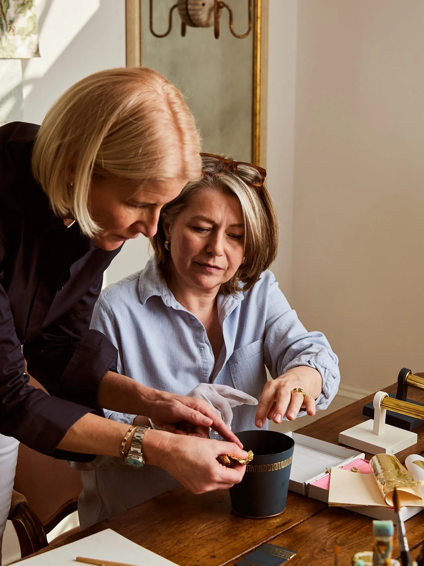 Every gilded detail on our sconces is specified by you and hand-applied in our studio to create truly one-of-a-kind pieces. Here we are working on a meander border design for our soon to be launched t&ocirc;le shade. Can&rsquo;t wait to collaborate o