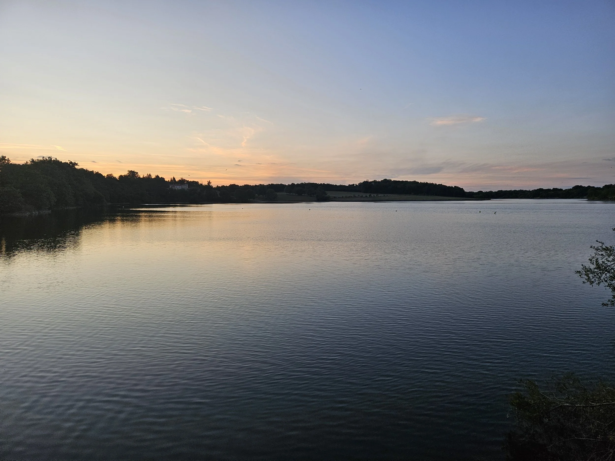 A calm river or lake during sunset with a quote relating to mental health.