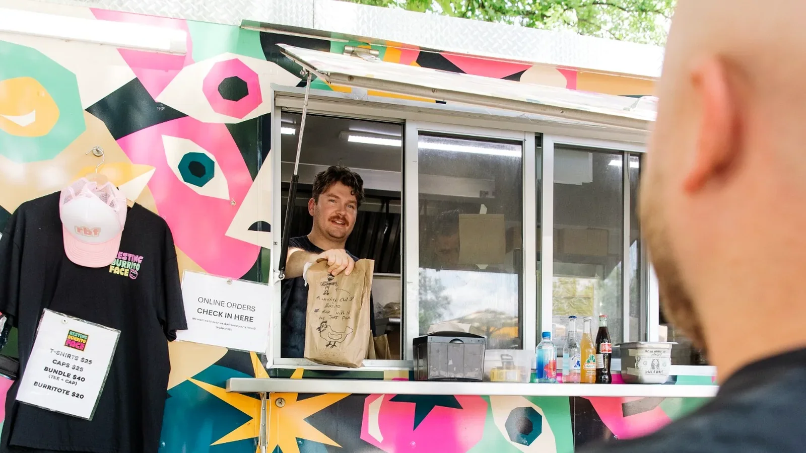 Resting Burrito Face Germantown Nashville food truck serving an order from the window under the trees.