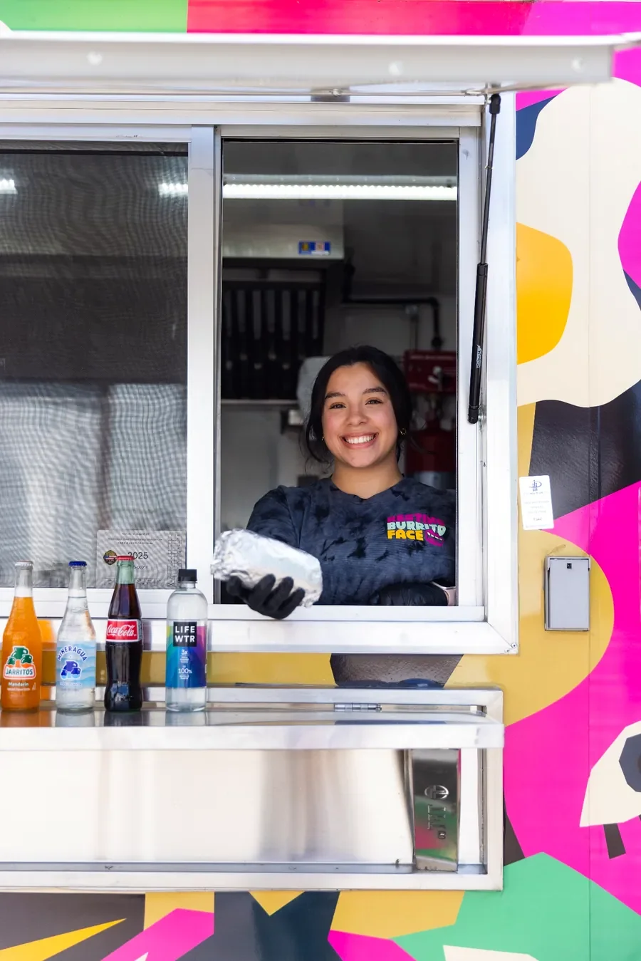 Resting Burrito Face team member serving breakfast burritos from the Wedgewood Houston Nashville location window