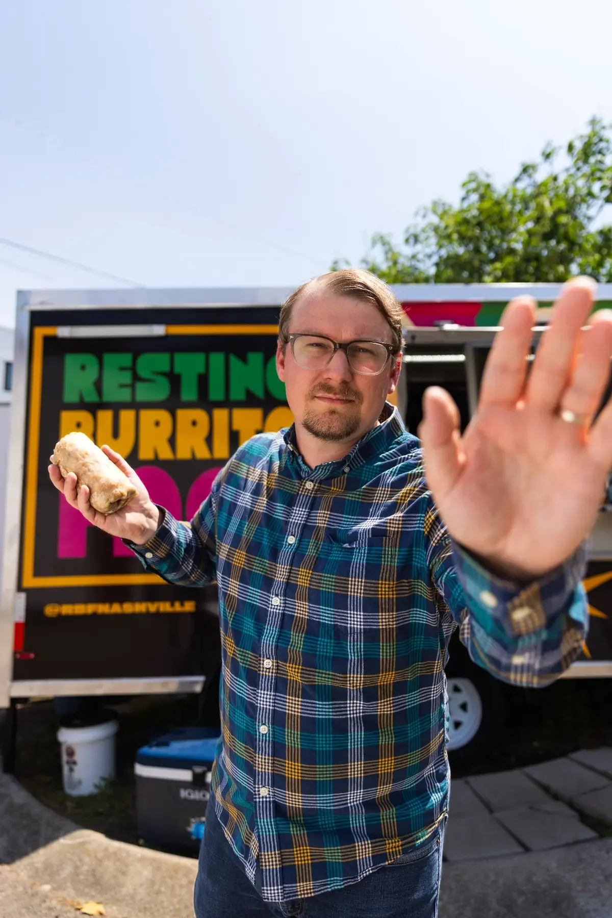 Resting Burrito Face founder holding a breakfast burrito in front of the Nashville food truck