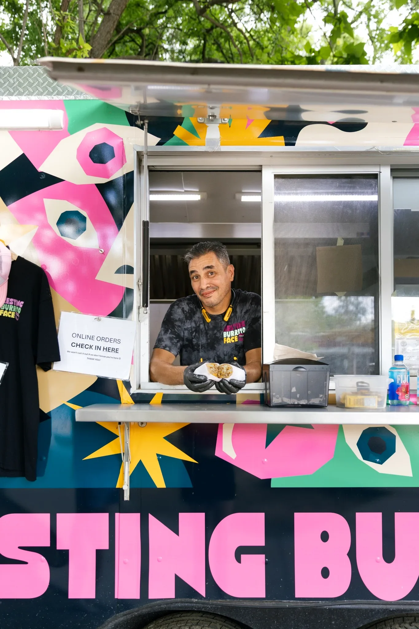 Resting Burrito Face team member serving a breakfast burrito from the Germantown Nashville food truck.