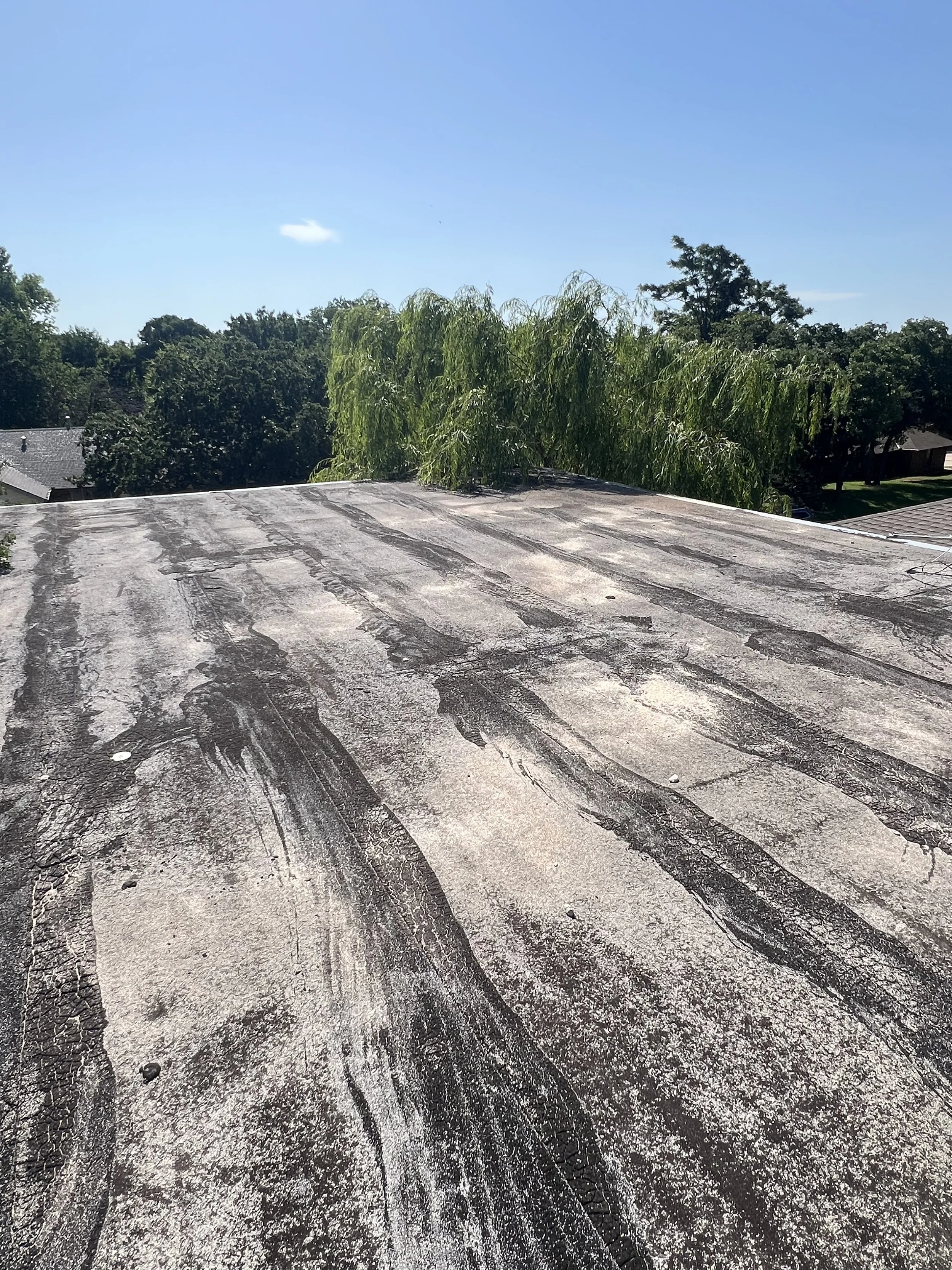 Before: Residential Flat Roof Storm Damage
Residential flat roof showing signs of Oklahoma storm exposure before repairs begin. Hail, high winds, and heavy rain can damage flat and low-slope roofing membranes, flashing, seams, and drainage areas, som