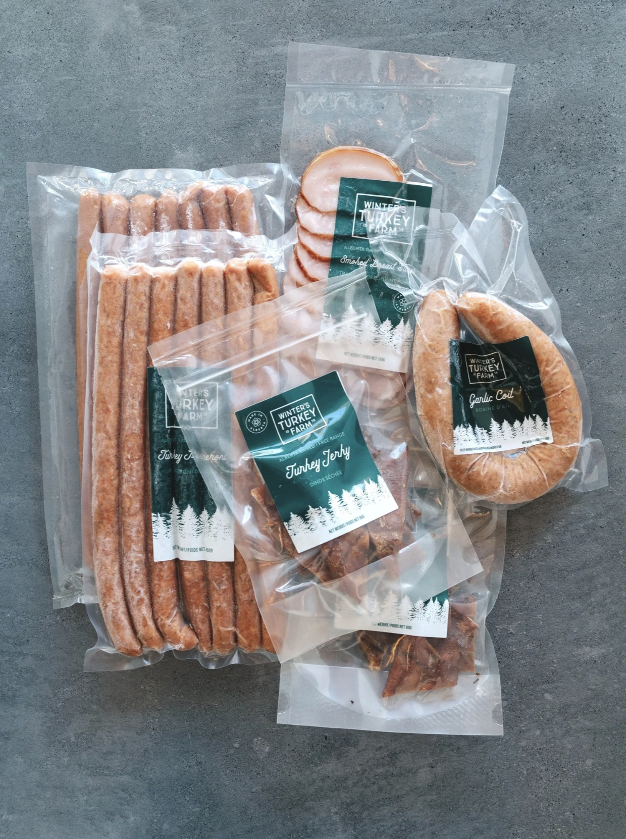 Packaged turkey meats including turkey sausage links, sliced smoked breast turkey, garlic coil sausage, and turkey jerky, all from Winter's Turkey Farm.