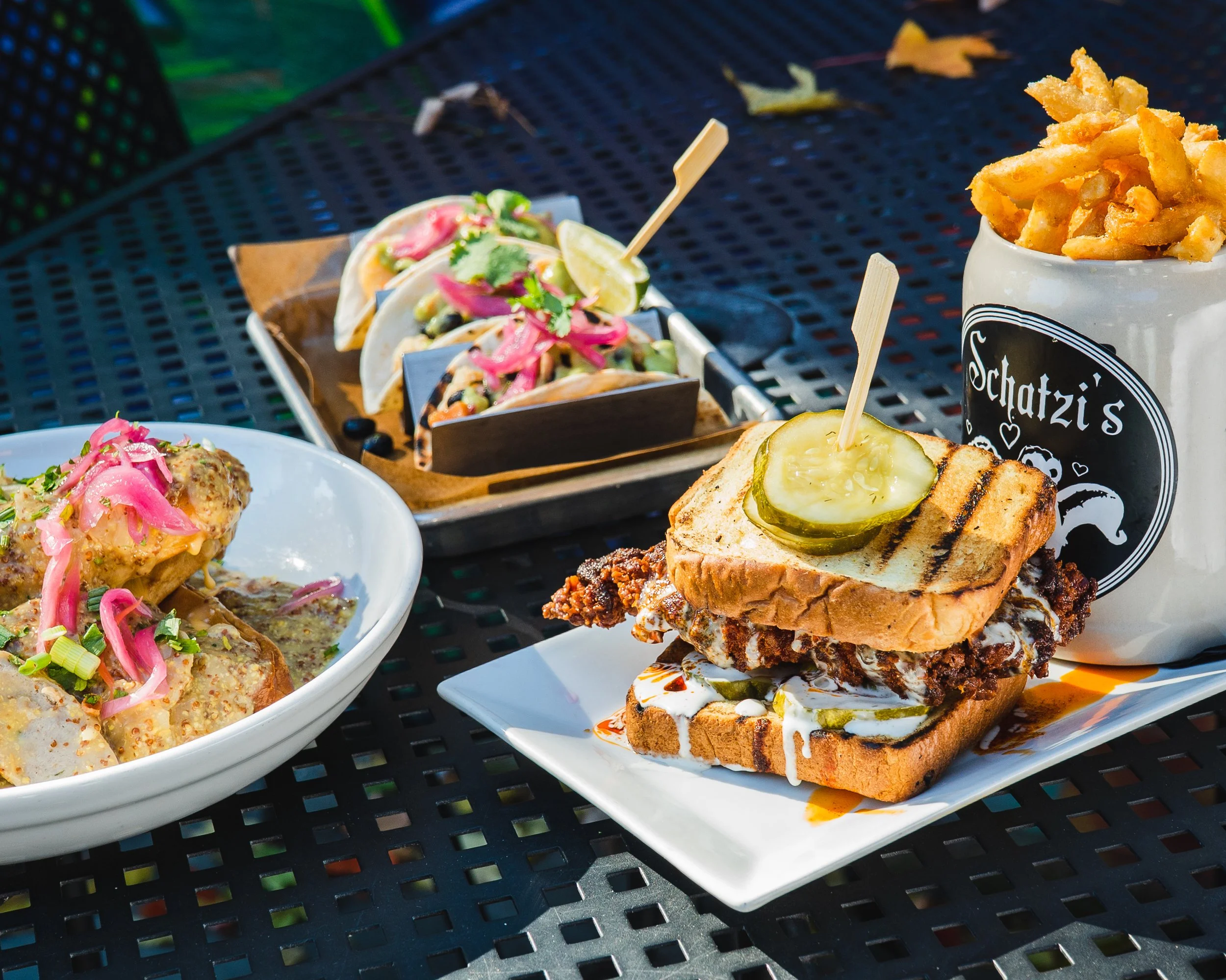 Eye level table spread of hot chicken sandwich, tacos, and fries - bright food photography - Hudson Valley, Poughkeepsie, NY