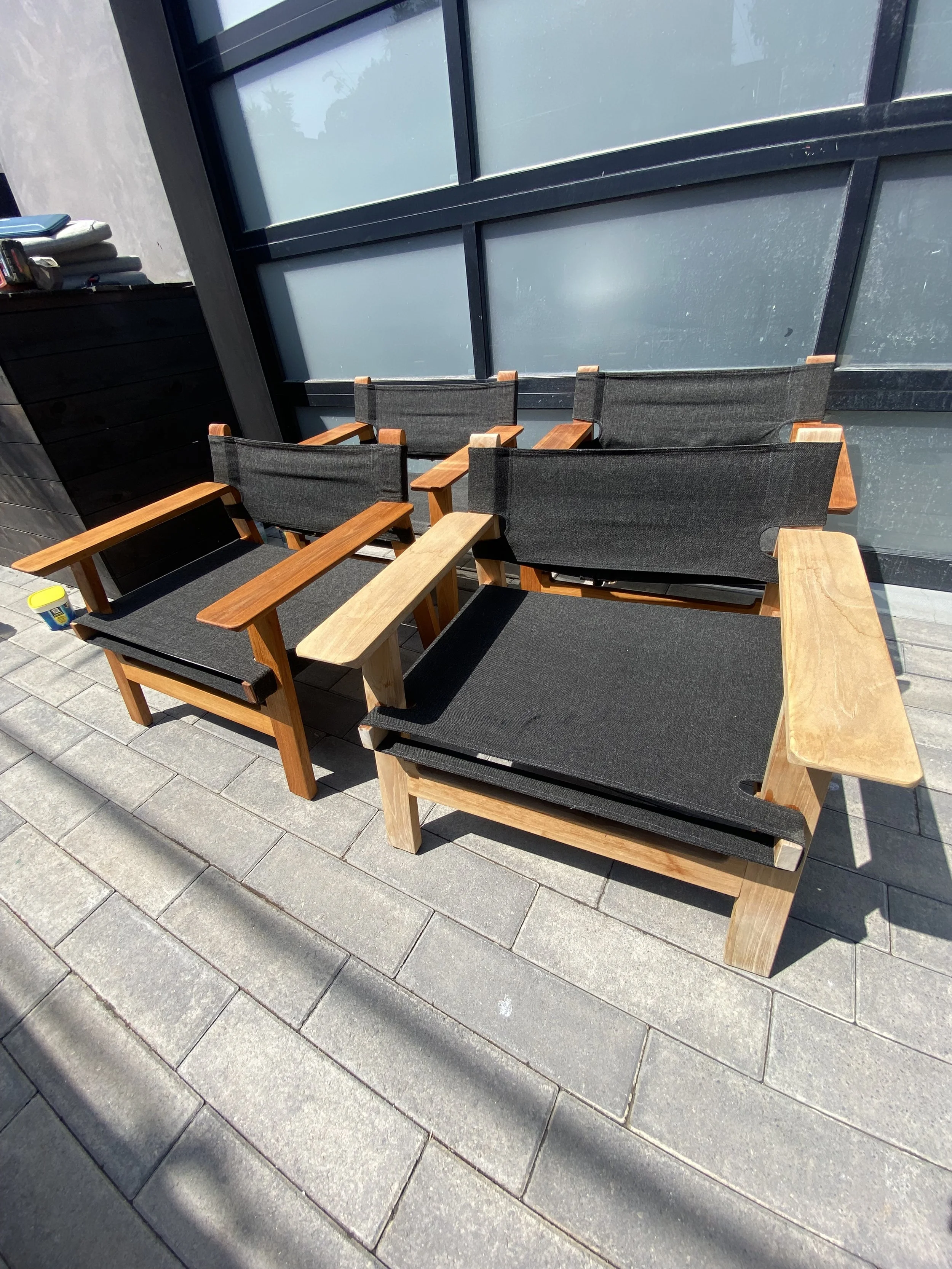 Outdoor chair repair showing fresh wood armrest installation during maintenance visit.