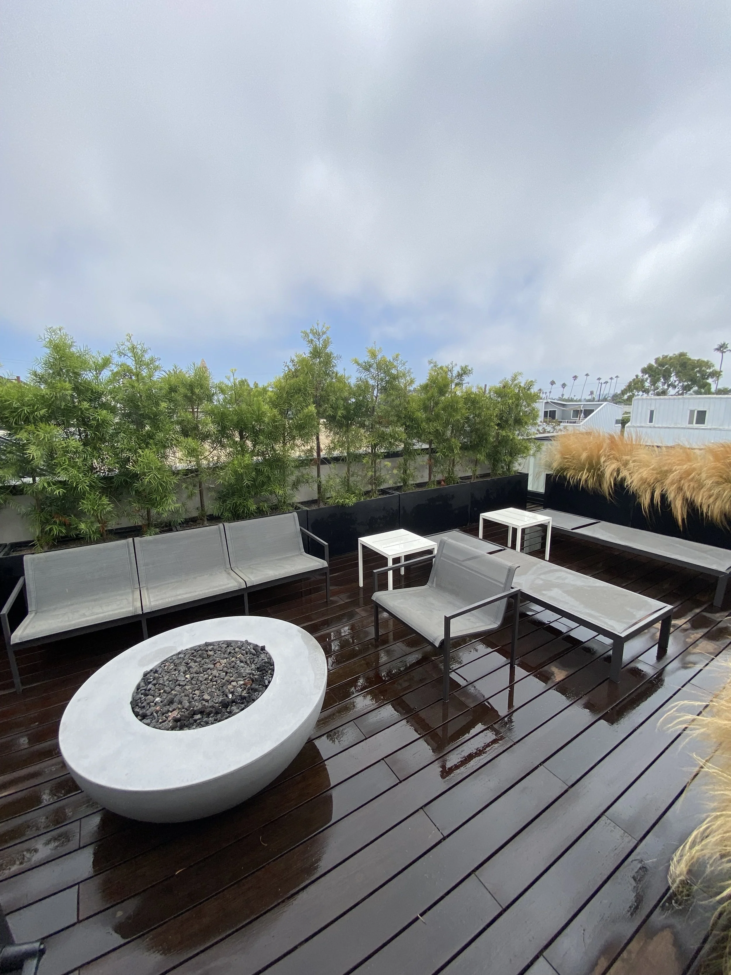 deck with built-in fire pit and seating area – luxury backyard setup in West LA