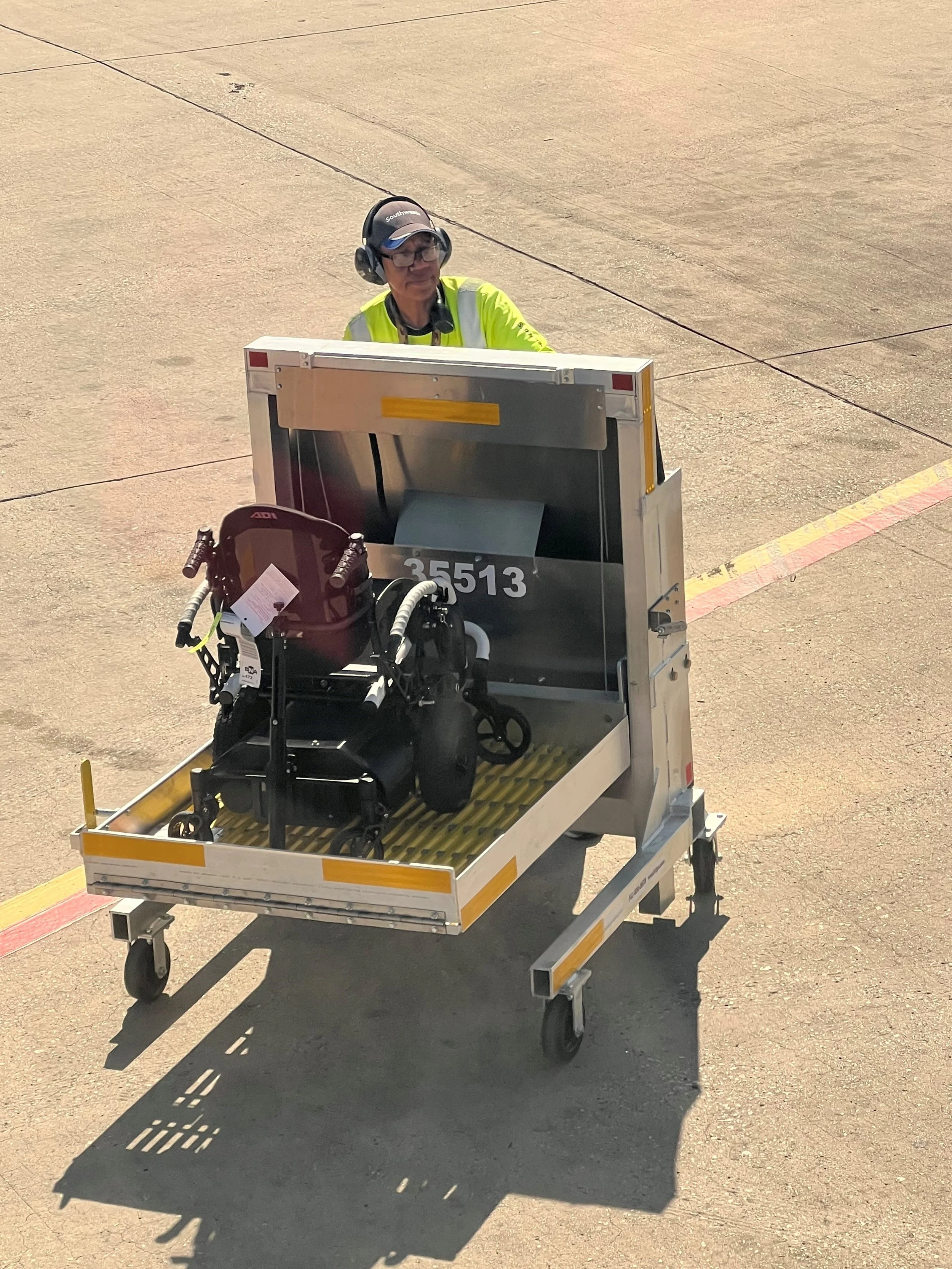 The power flex solution at an airport before being loaded onto the baggage carousel with a wheelchair in the foreground.